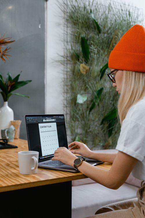 Woman creating content plan using free downloadable template