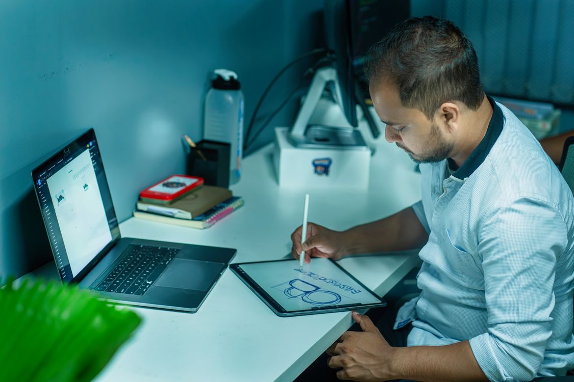 Designer sketching brand logo concept on tablet using free tools