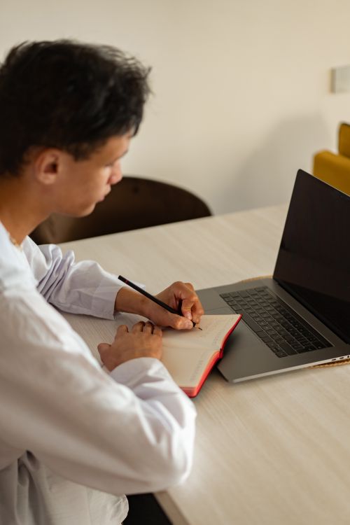 How to Learn Digital Skills for Free 1 Person learning digital skills hands-on at desk with laptop