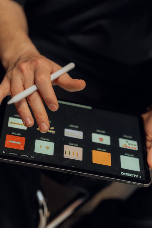 Person using digital tablet with stylus for toolkit templates