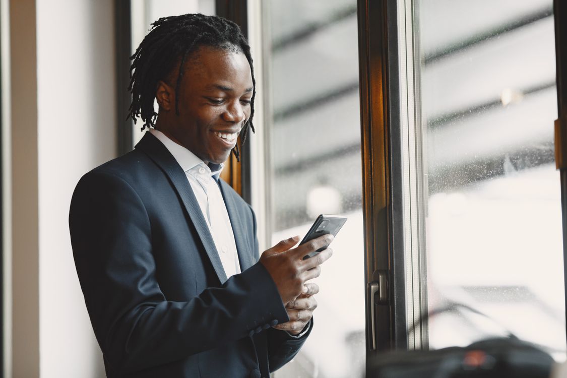 Business owner smiling while AI chatbot handles customer service
