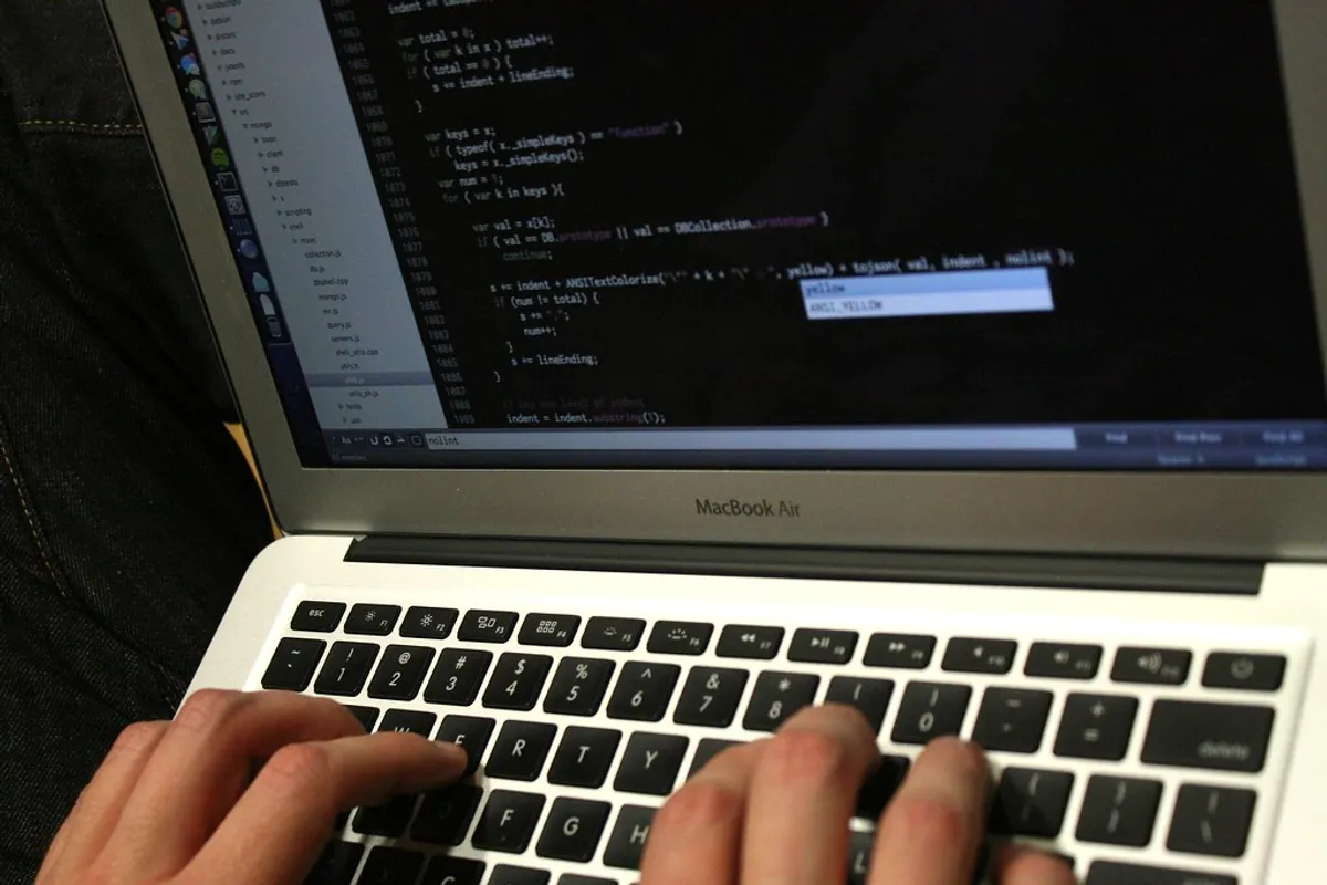 What Is an AI Coding Assistant? A Beginner's Guide for 2026 2 Types of AI coding assistant on a laptop screen